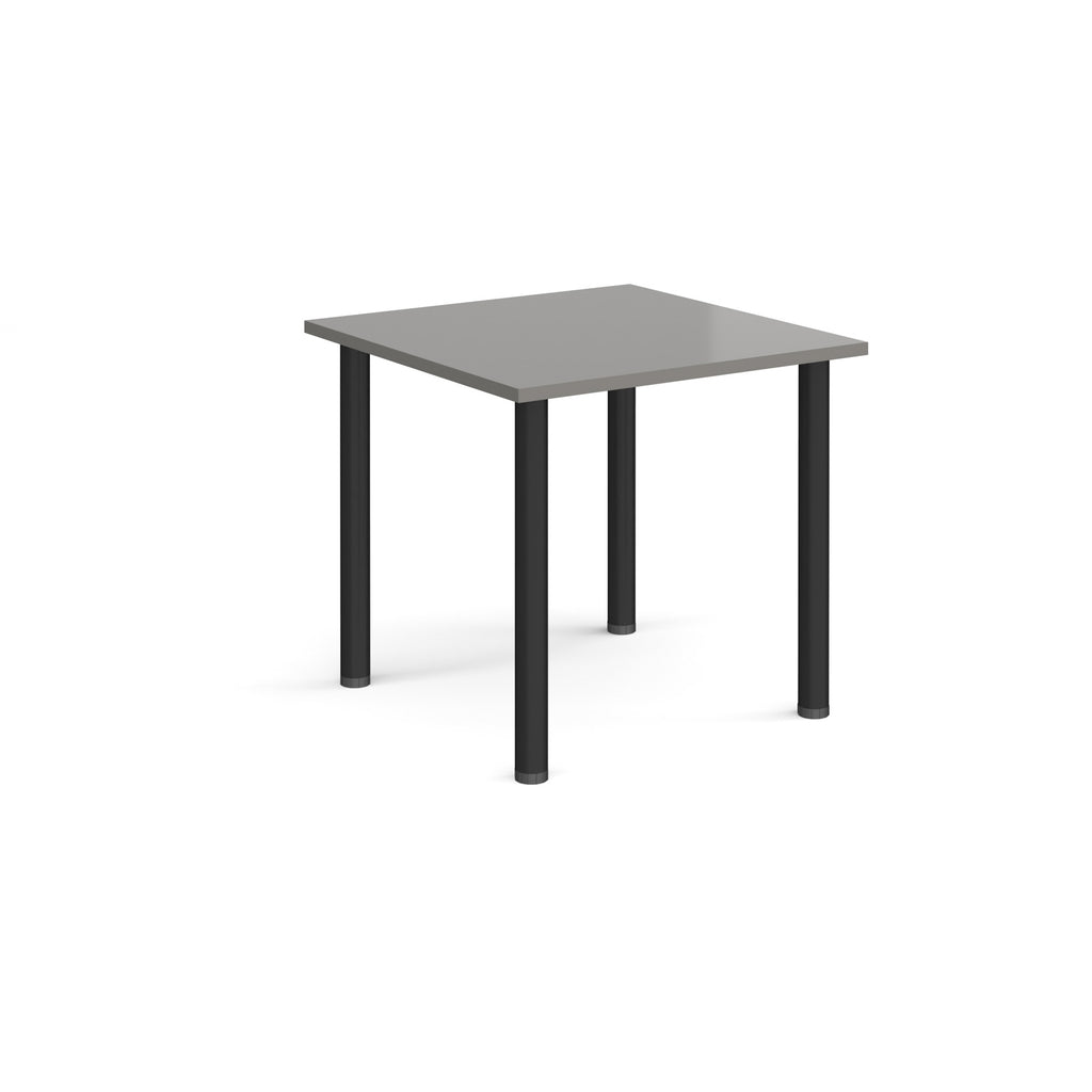 Square table with grey top and black legs on a white background