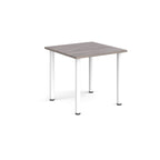 Square table with grey wood-effect  top and white legs on a white background