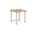 Square table with wood-effect top and white legs on a white background