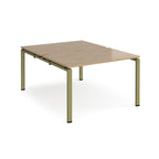 Back-to-back desk with wood-effect top and green metal frame on a white background