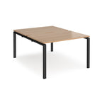 Back-to-back desk with wood-effect top and black metal frame on a white background