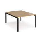 Back-to-back desk with wood-effect top and black metal frame on a white background