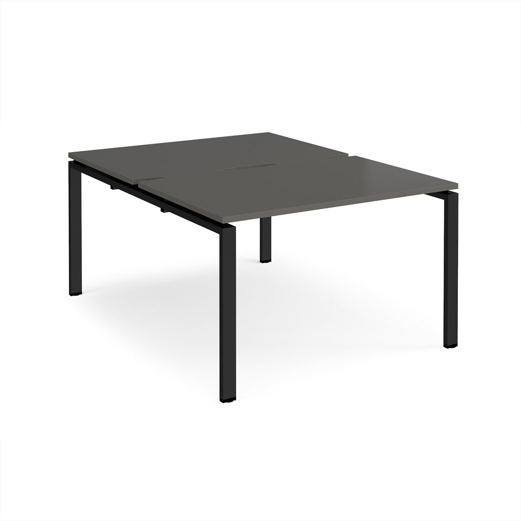 Back-to-back desk with grey top and black metal frame on a white background