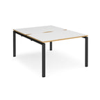 Back-to-back desk with white top with wooden edges and black metal frame on a white background