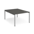 Back-to-back desk with grey top and silver metal frame on a white background