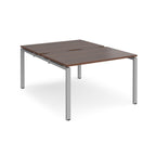 Back-to-back desk with wood-effect top and silver metal frame on a white background