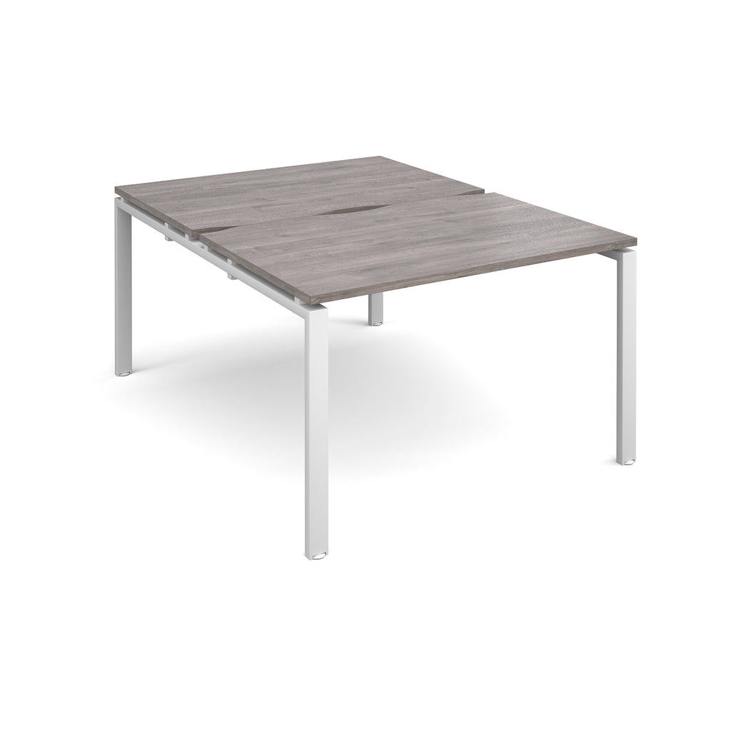 Back-to-back desk with grey wood-effect top and white metal frame on a white background