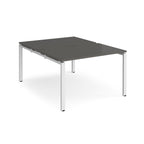 Back-to-back desk with grey top and white metal frame on a white background
