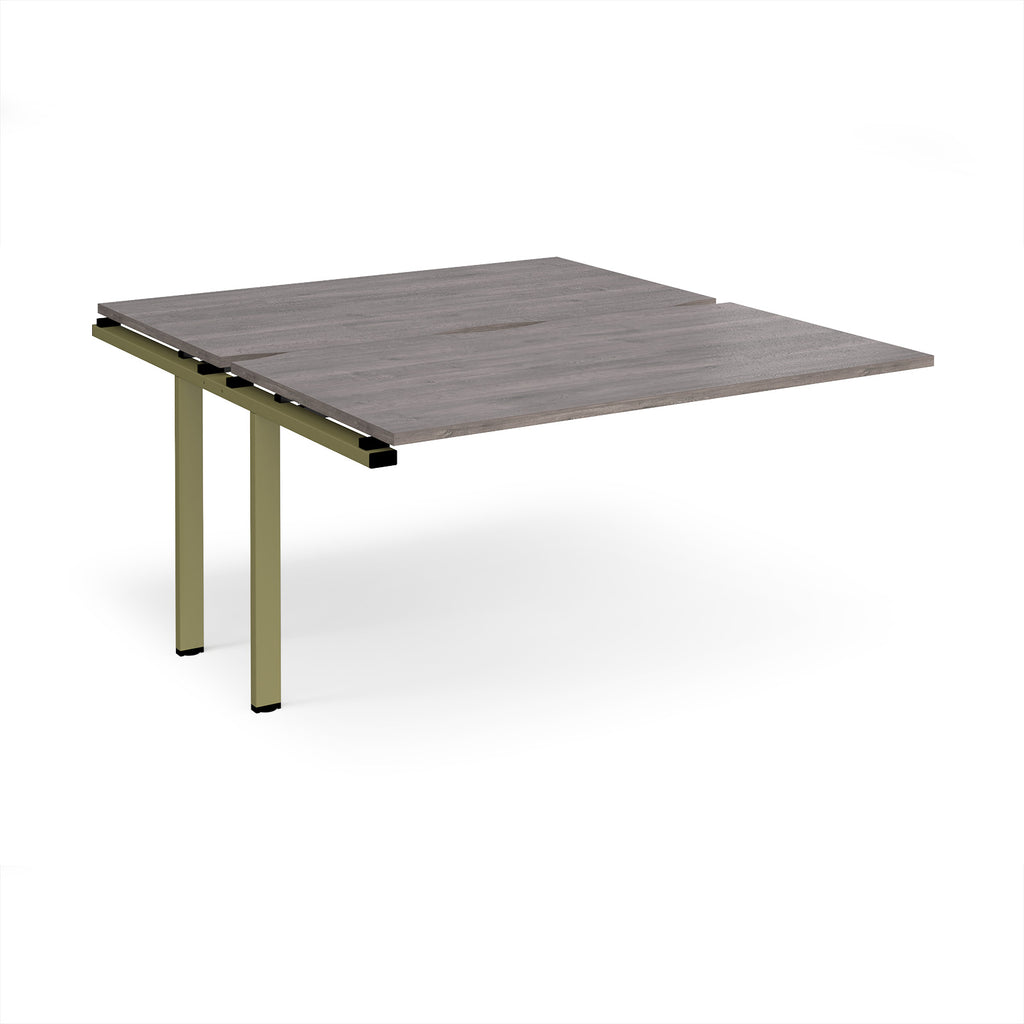 Desk add-on unit with grey wood-effect top and green metal frame on a white background