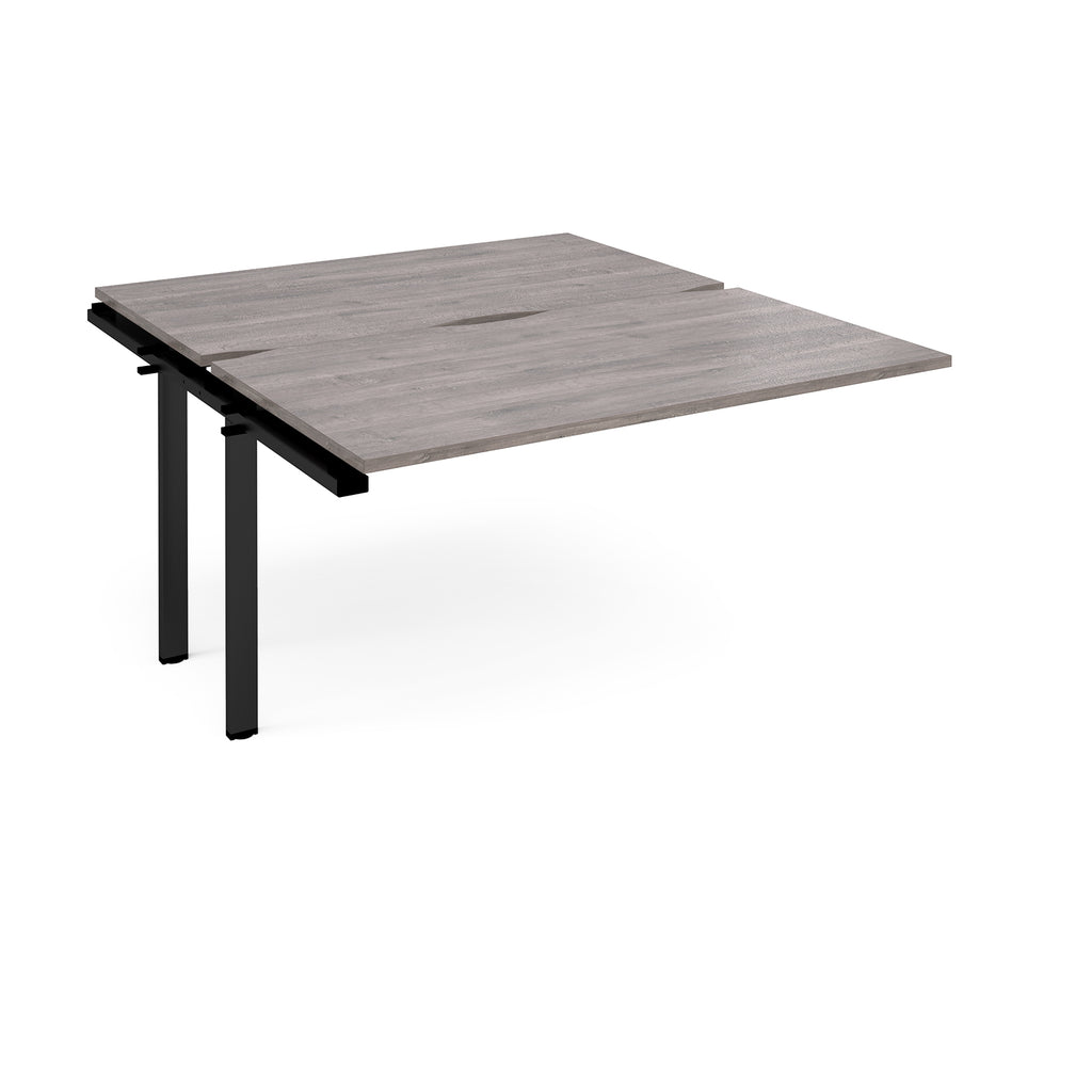 Desk add-on unit with grey wood-effect top and black metal frame on a white background