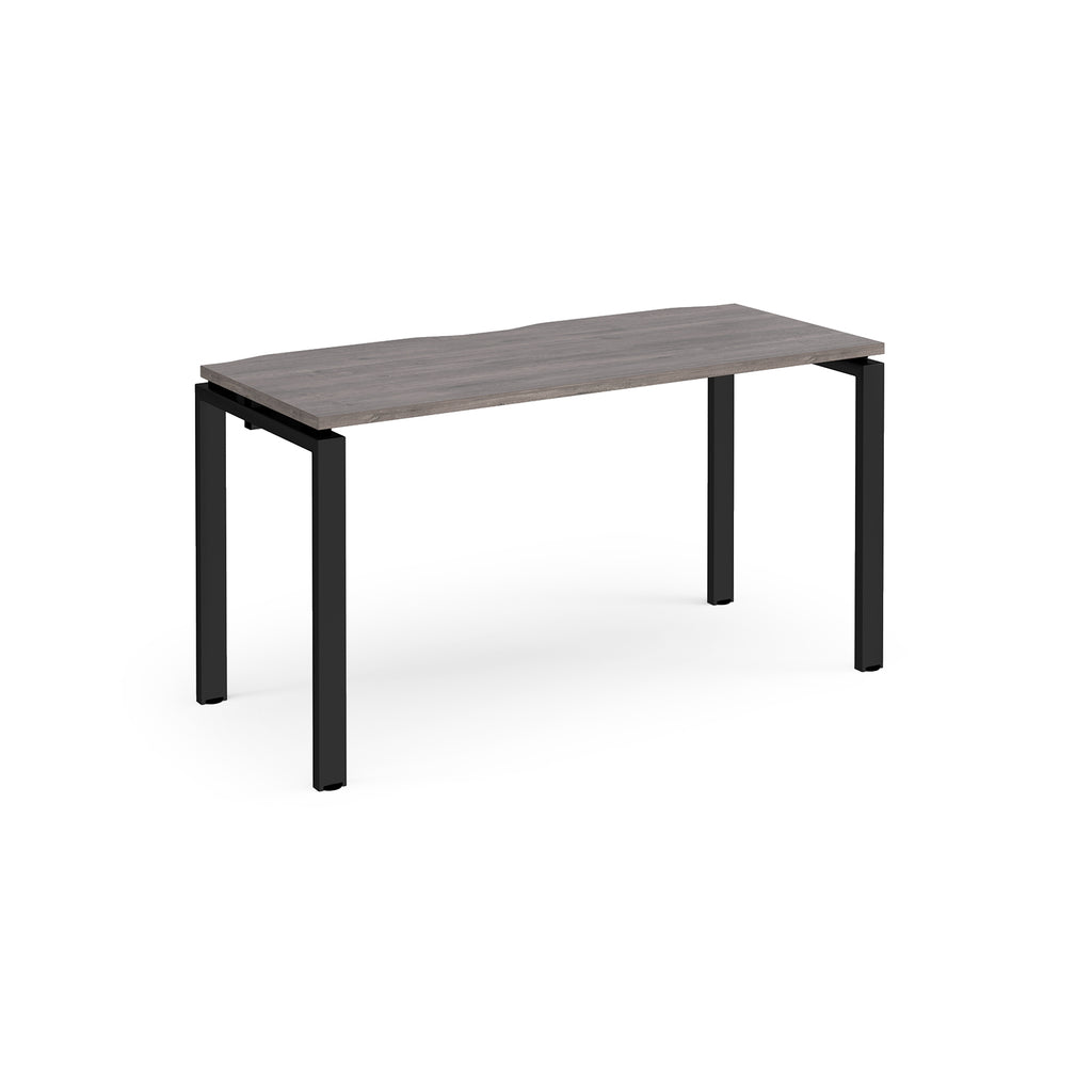 Rectangular desk with grey wood-effect top with black metal frame on a white background