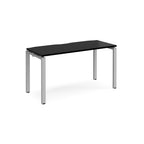 Rectangular desk with black top with silver metal frame on a white background