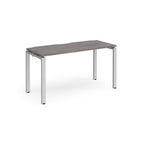 Rectangular desk with grey wood-effect top with silver metal frame on a white background