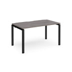 Rectangular desk with grey wood-effect top and black metal frame on a white background