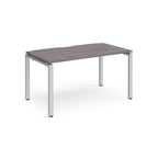 Rectangular desk with grey wood-effect top and silver metal frame on a white background