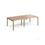 Four back-to-back desks with wood-effect tops and green metal frame on a white background