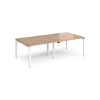 Four back-to-back desks with white tops and white metal frame on a white background