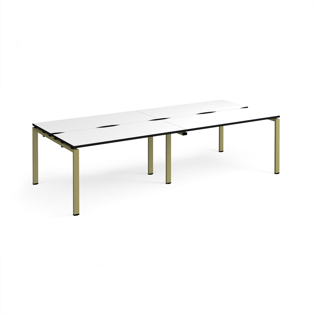 Four back-to-back desks with white tops with black edges and green metal frame on a white background