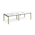 Four back-to-back desks with white tops with black edges and green metal frame on a white background