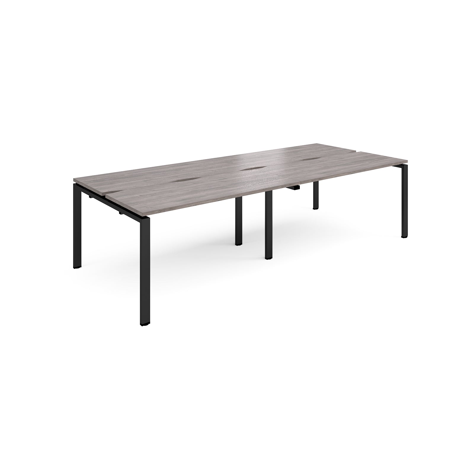 Four back-to-back desks with grey wood-effect tops and black metal frame on a white background