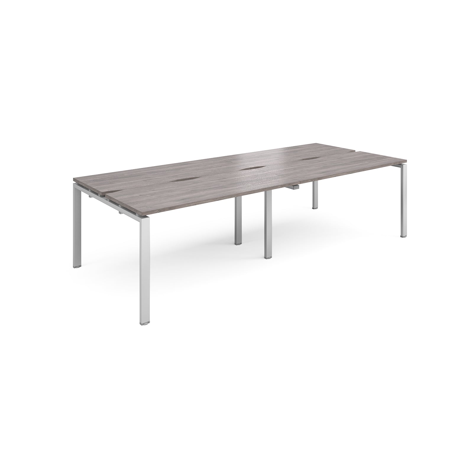 Four back-to-back desks with grey wood-effect tops and silver metal frame on a white background