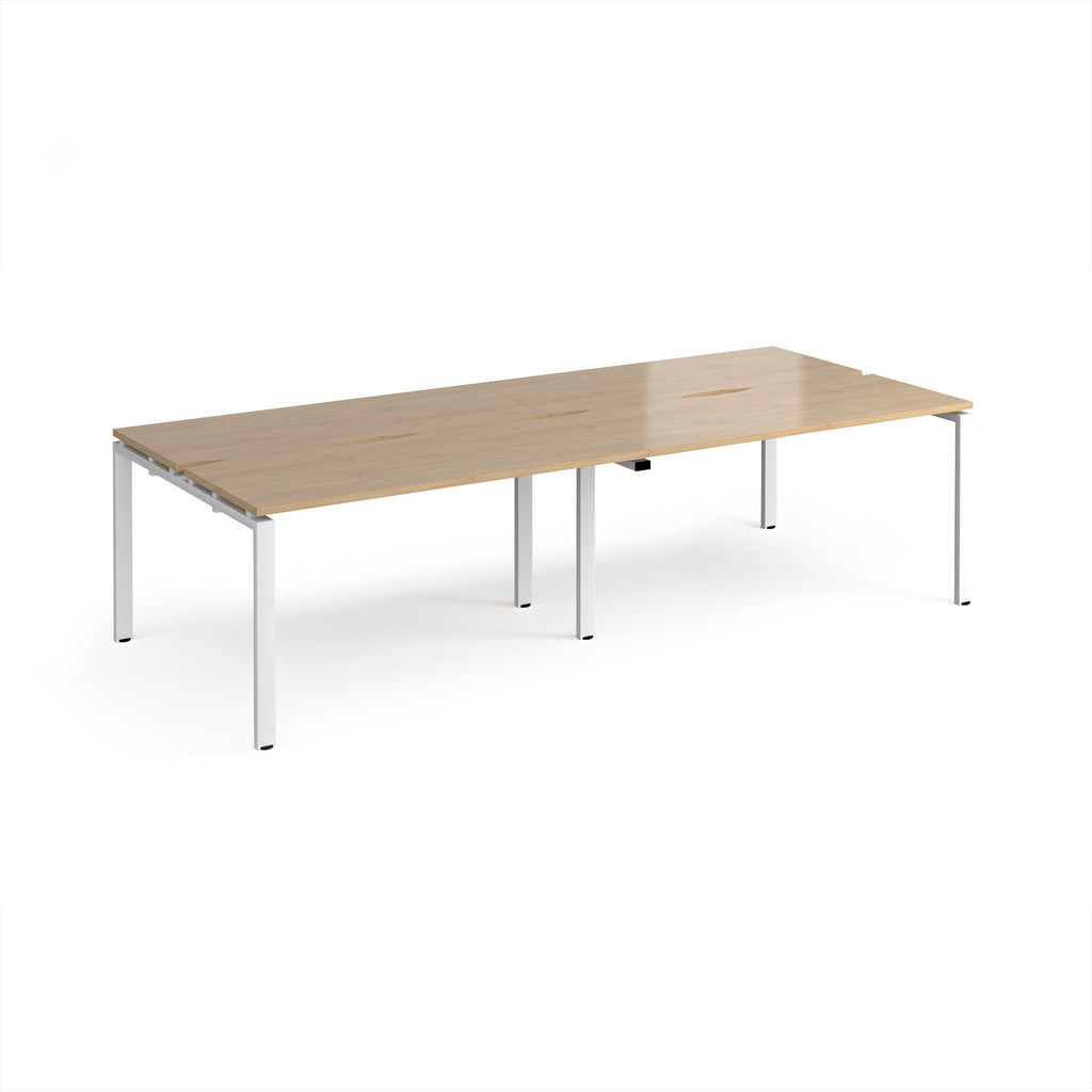 Four back-to-back desks with wood-effect tops and white metal frame on a white background