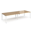 Four back-to-back desks with wood-effect tops and white metal frame on a white background