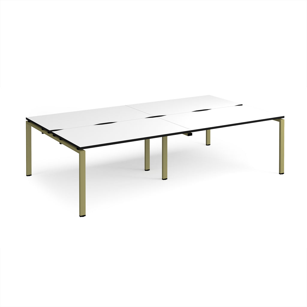 Four back-to-back desks with white tops with black edges and green metal frame on a white background