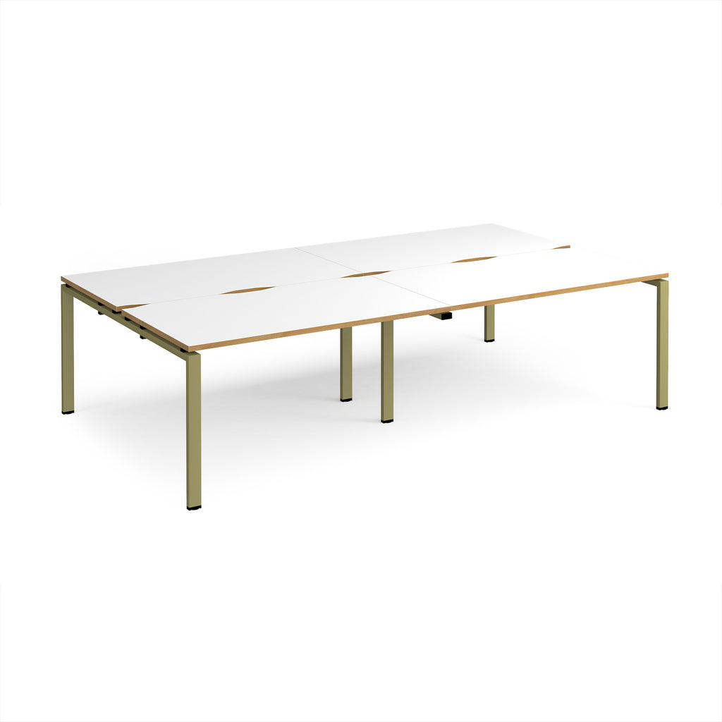 Four back-to-back desks with white tops with wooden edges and green metal frame on a white background