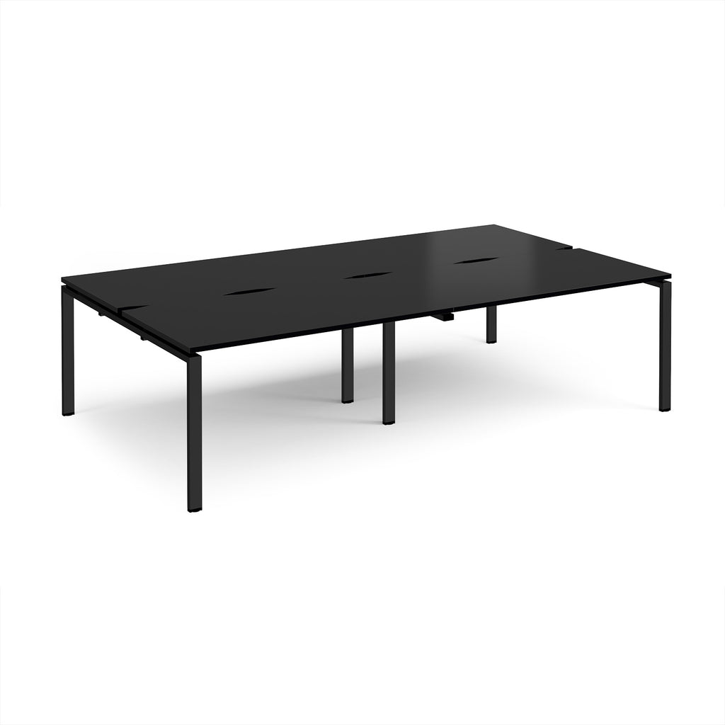Four black back-to-back desks with metal frame on a white background