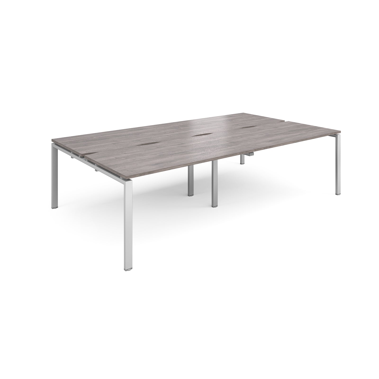 Four back-to-back desks with grey wood-effect tops and silver metal frame on a white background