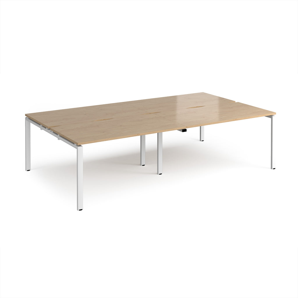 Four back-to-back desks with wood-effect tops and white metal frame on a white background