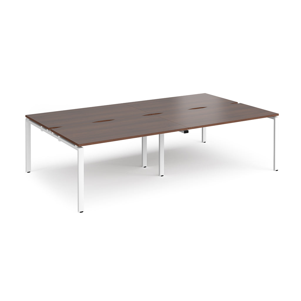 Four back-to-back desks with wood-effect tops and white metal frame on a white background