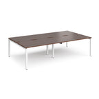 Four back-to-back desks with wood-effect tops and white metal frame on a white background