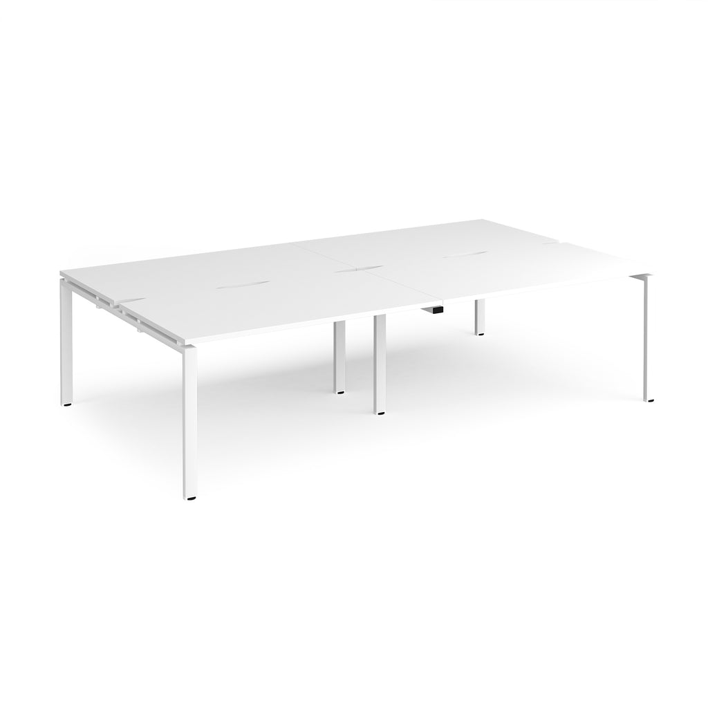 Four white back-to-back desks with metal frame on a white background
