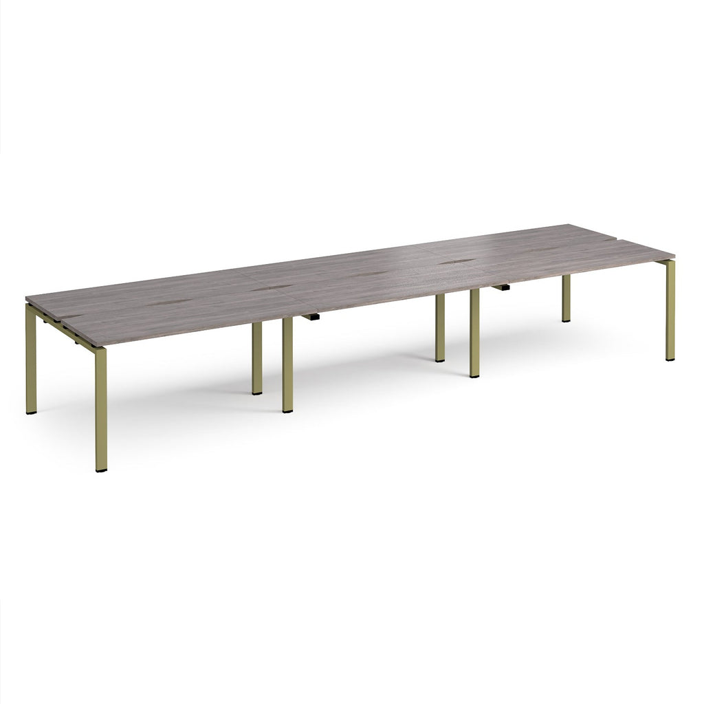 Long back-to-back desk with grey wood-effect top and green metal frame on a white background