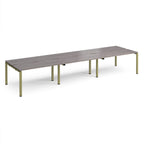 Long back-to-back desk with grey wood-effect top and green metal frame on a white background
