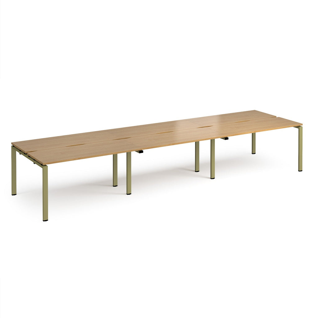 Long back-to-back desk with wood-effect top and green metal frame on a white background