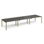 Long back-to-back desk with grey top and green metal frame on a white background