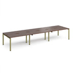 Long back-to-back desk with wood-effect top and green metal frame on a white background