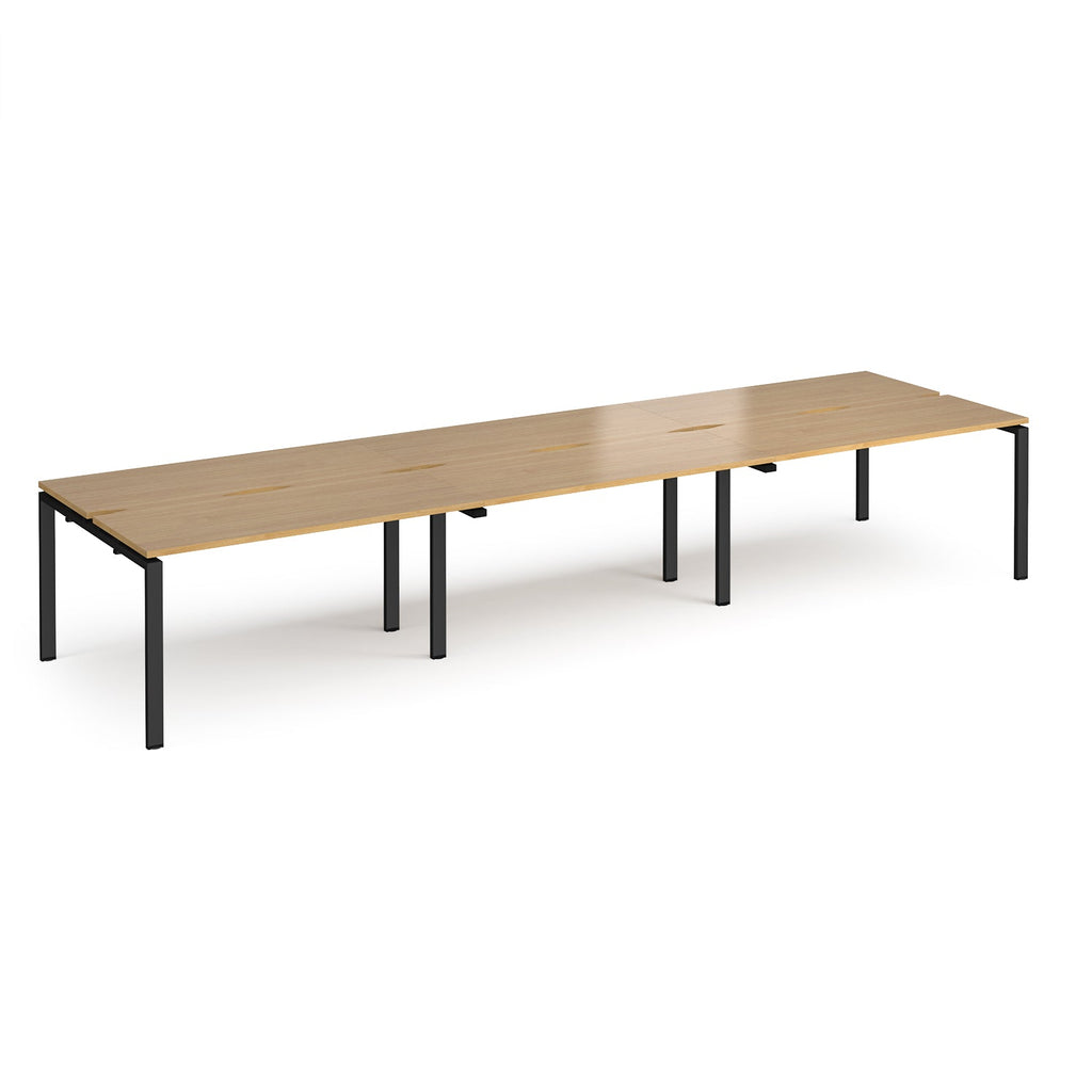 Long back-to-back desk with wood-effect top and black metal frame on a white background