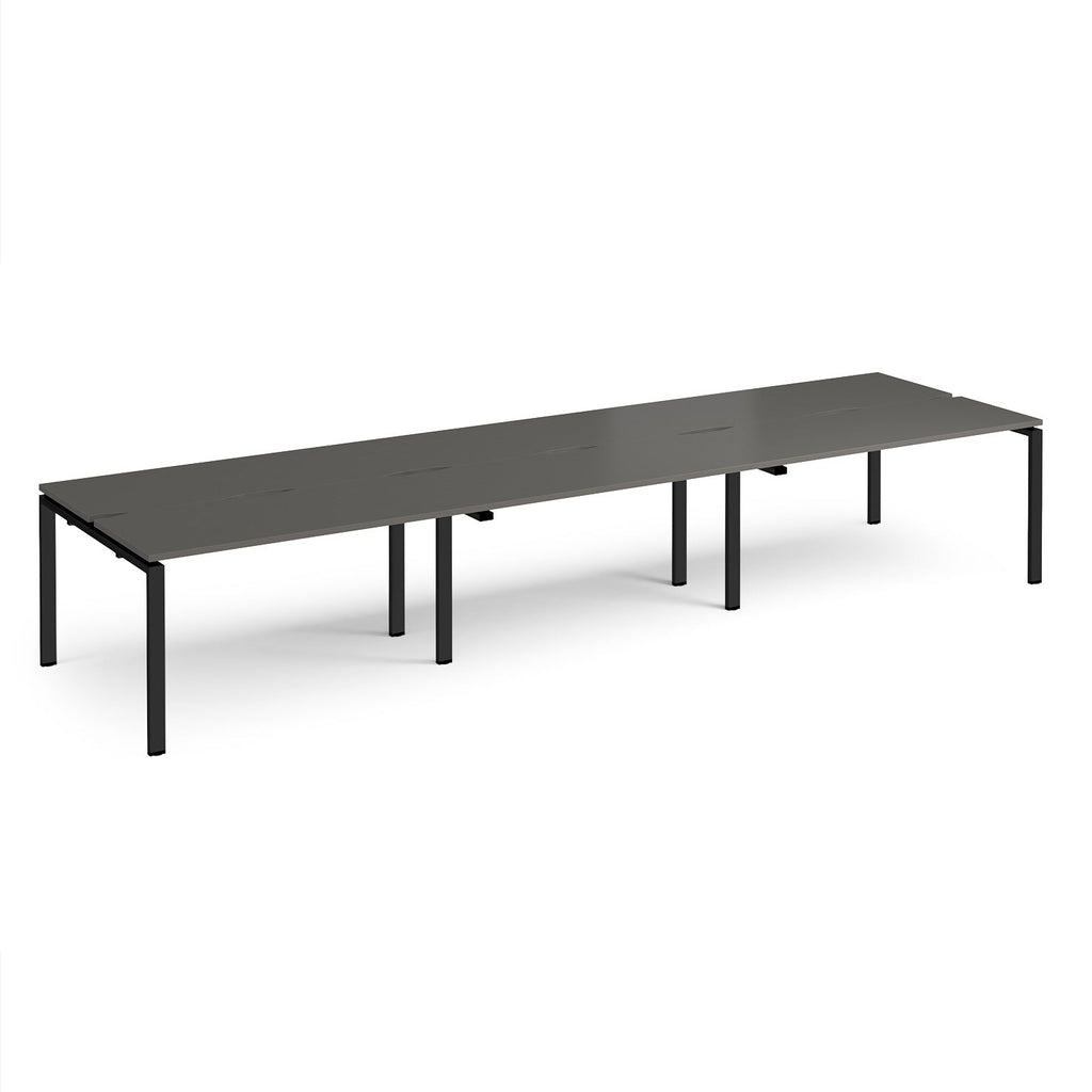 Long back-to-back desk with grey top and black metal frame on a white background