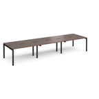 Long back-to-back desk with wood-effect top and black metal frame on a white background
