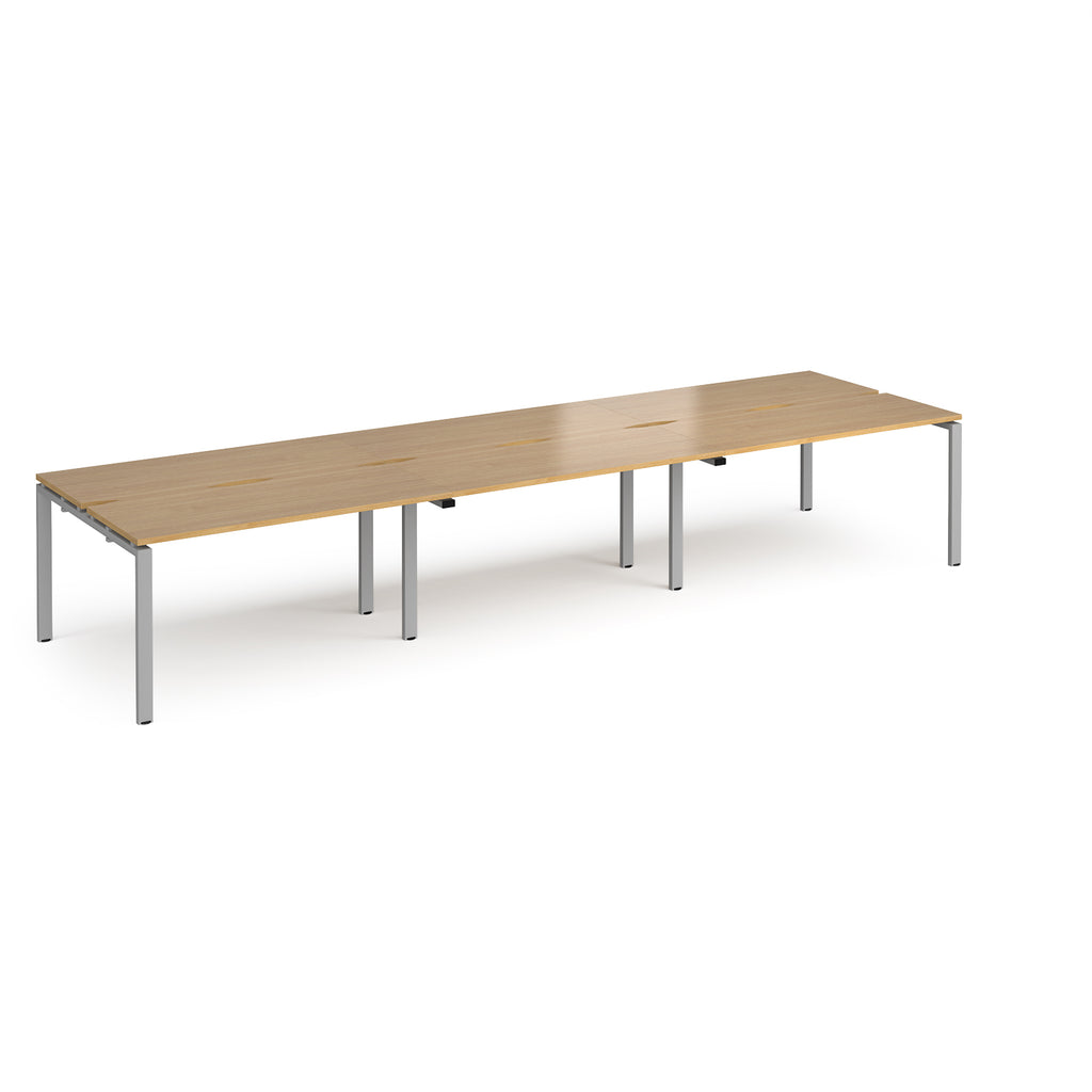 Long back-to-back desk with wood-effect top and silver metal frame on a white background