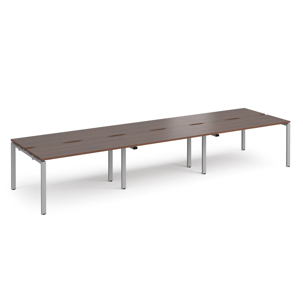 Long back-to-back desk with wood-effect top and silver metal frame on a white background