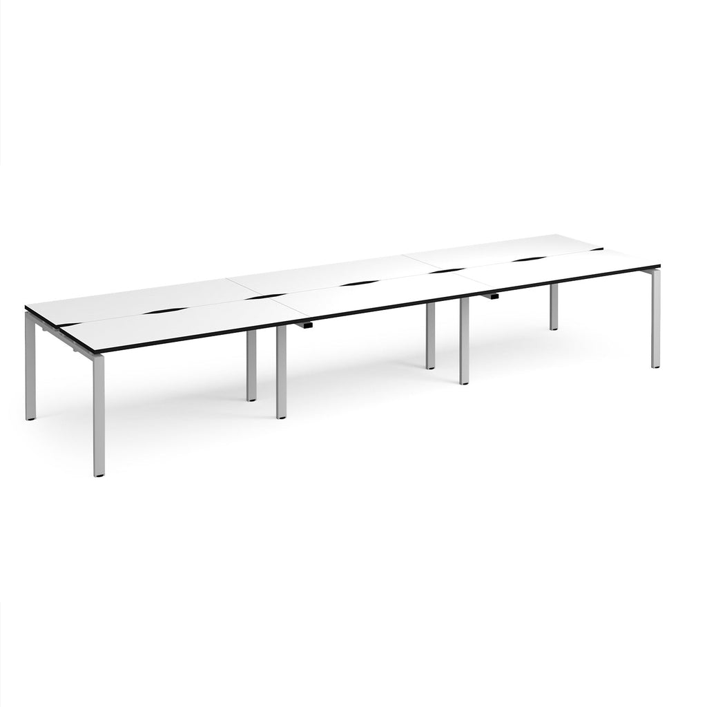 Long back-to-back desk with white top with black edges and silver metal frame on a white background