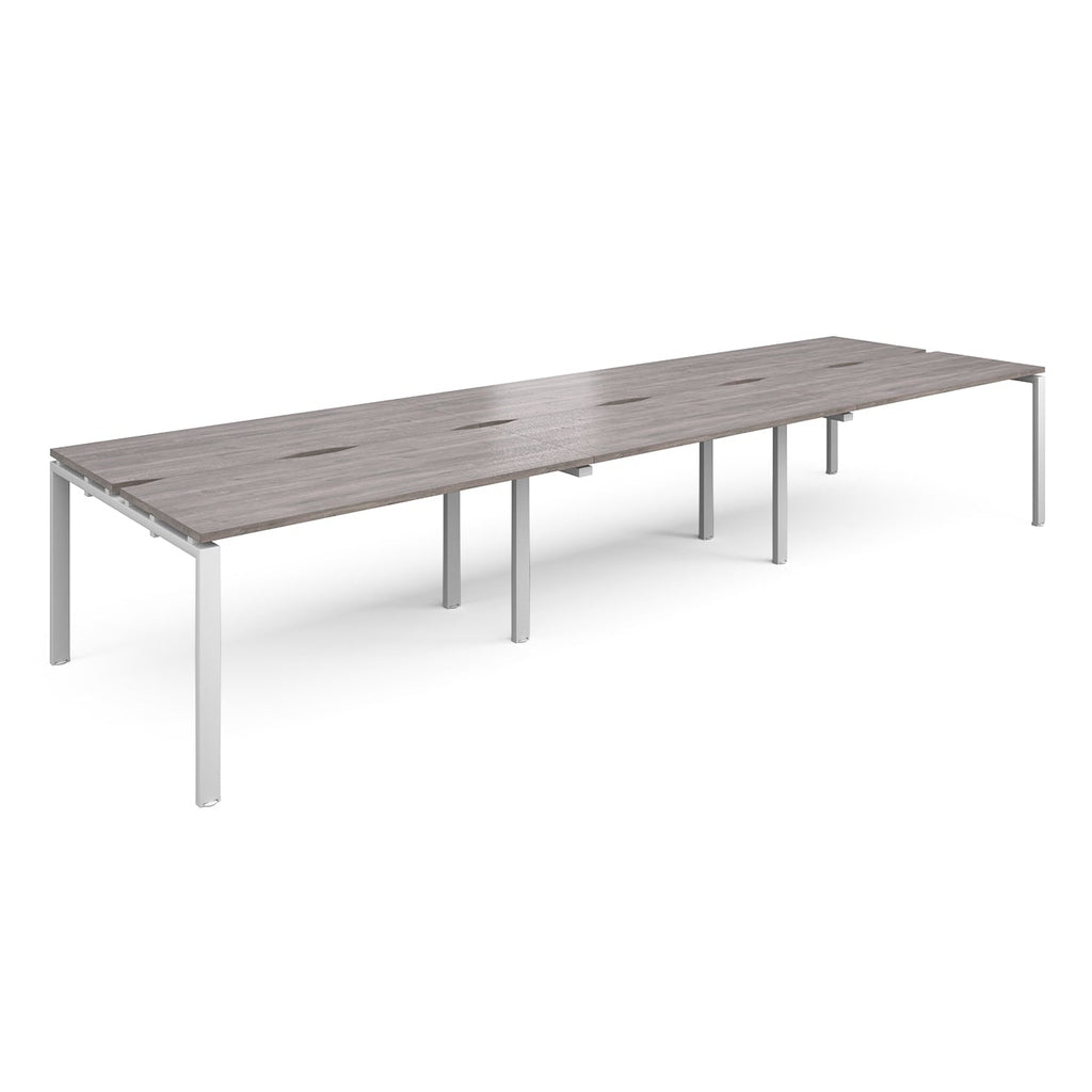 Long back-to-back desk with grey wood-effect top and white metal frame on a white background