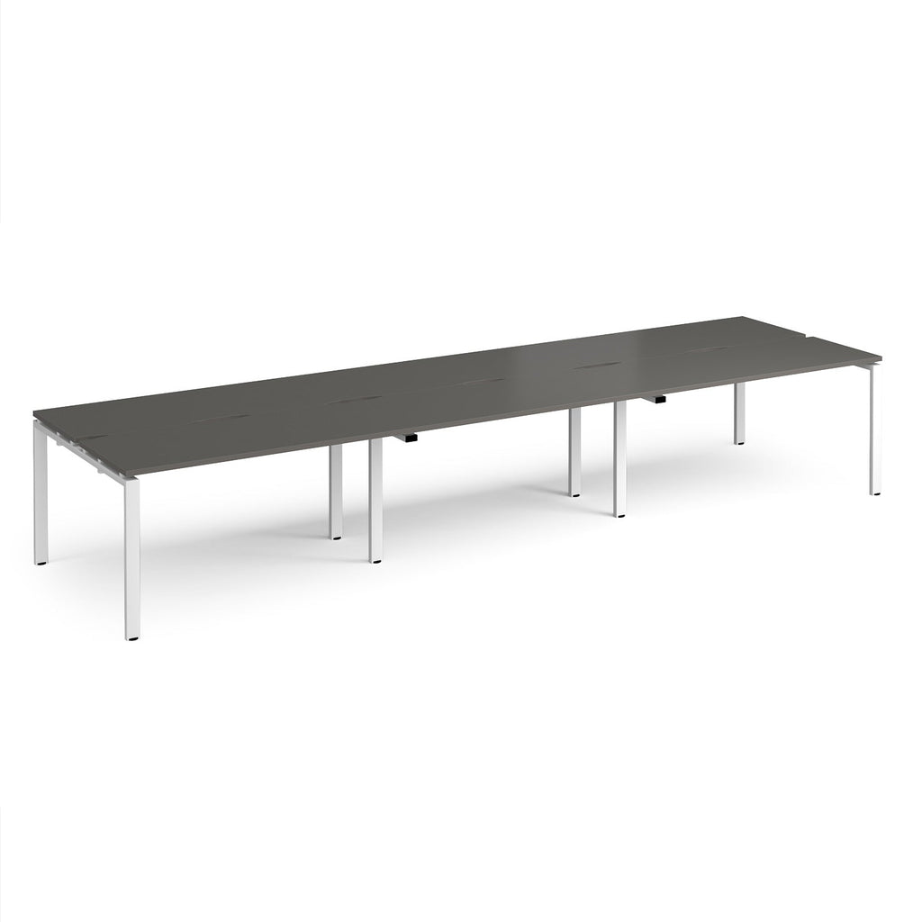 Long back-to-back desk with grey top and white metal frame on a white background