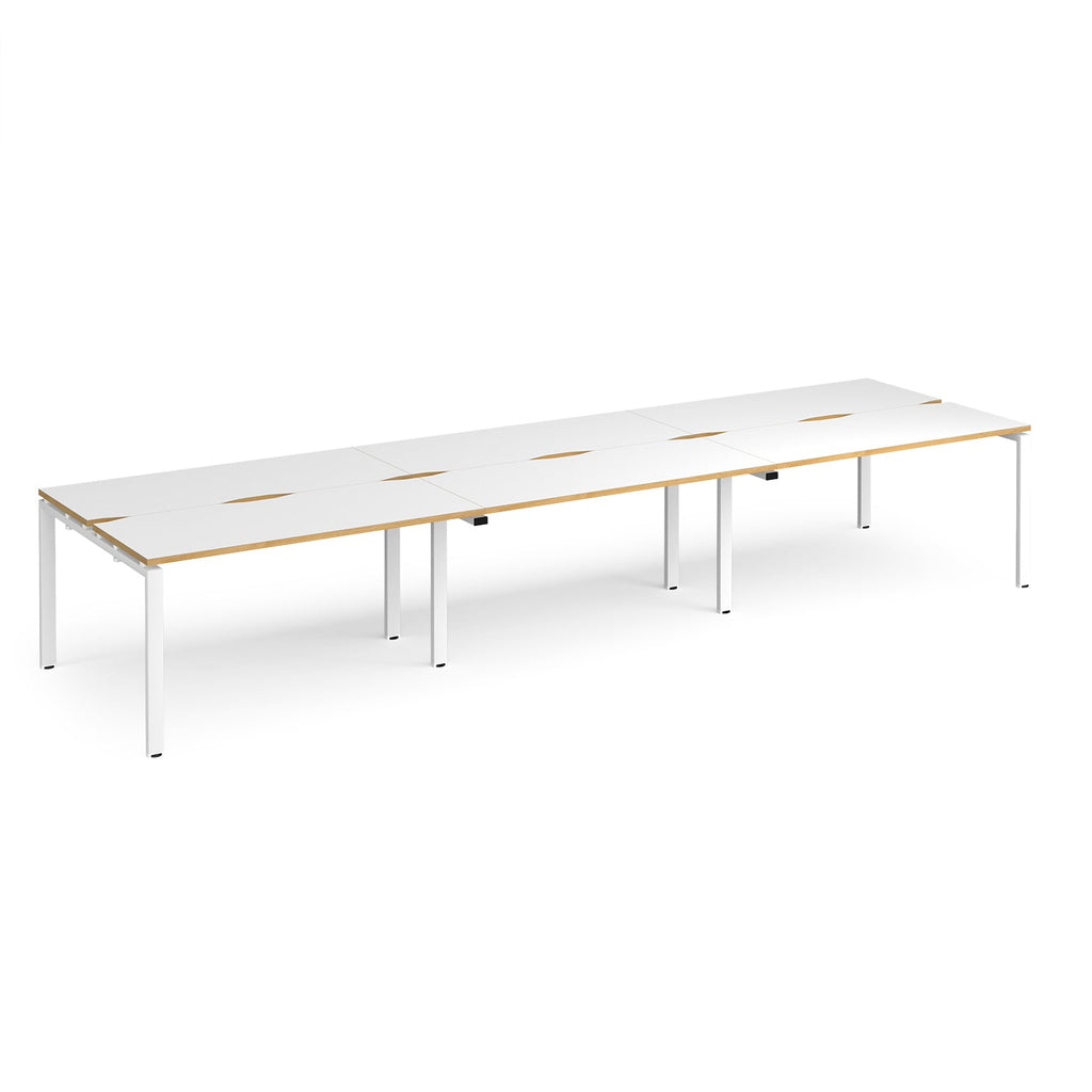 Long back-to-back desk with white top with wooden edges and white metal frame on a white background