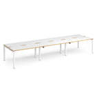 Long back-to-back desk with white top with wooden edges and white metal frame on a white background